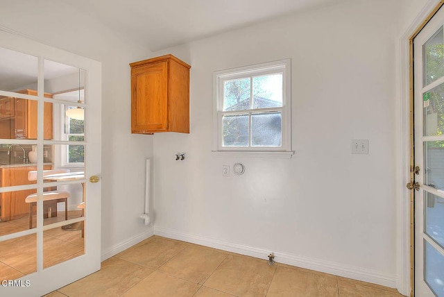 3671 Grayburn Rd, Pasadena, CA 91107 - laundry area with cabinet space, hookup for a gas dryer, plenty of natural light, and light tile patterned flooring