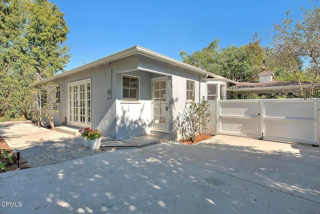 3671 Grayburn Rd, Pasadena, CA 91107 - view of front facade with stucco siding and a gate