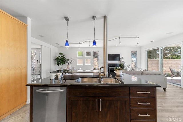 3496 Windspun, Huntington Beach, CA 92649 - kitchen featuring dark countertops, open floor plan, an island with sink, and hanging light fixtures