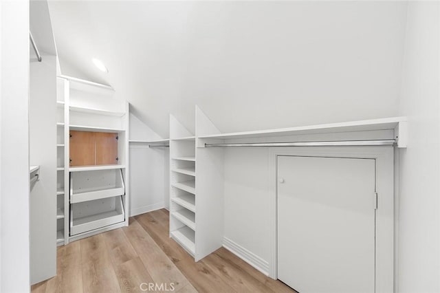 3496 Windspun, Huntington Beach, CA 92649 - spacious closet featuring lofted ceiling and light wood-style floors