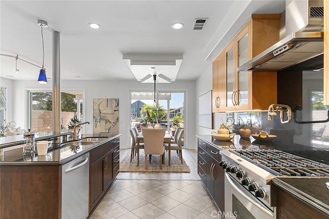 3496 Windspun, Huntington Beach, CA 92649 - kitchen with wall chimney exhaust hood, stainless steel appliances, dark countertops, light tile patterned flooring, and decorative backsplash