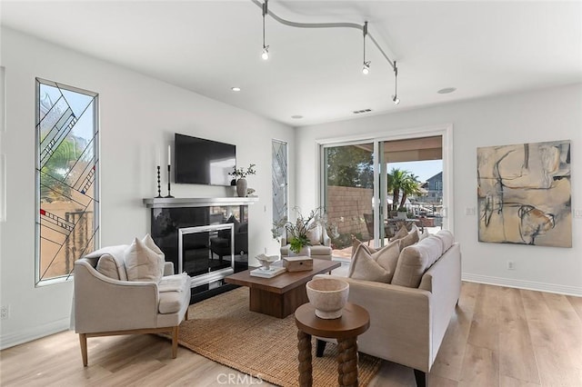 3496 Windspun, Huntington Beach, CA 92649 - living room with a glass covered fireplace, light wood-type flooring, and recessed lighting