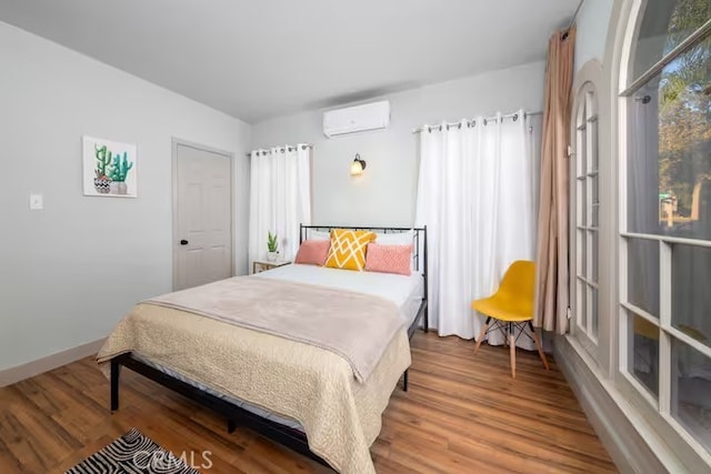 5743 Magnolia Ave, Riverside, CA 92506 - bedroom with an AC wall unit and wood finished floors