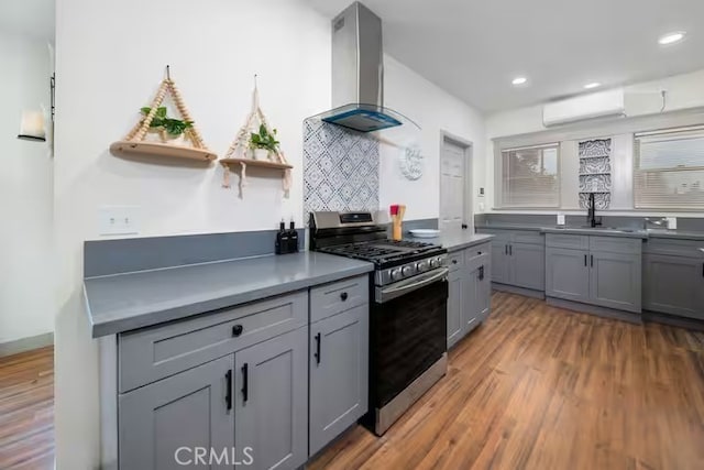 5743 Magnolia Ave, Riverside, CA 92506 - kitchen featuring gas stove, island exhaust hood, gray cabinets, an AC wall unit, and open shelves