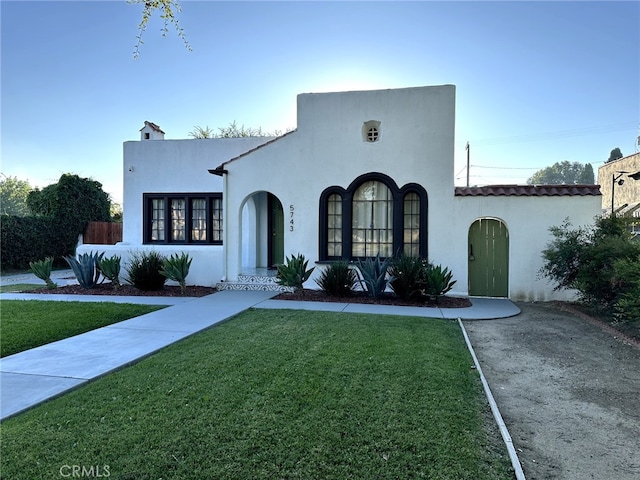 5743 Magnolia Ave, Riverside, CA 92506 - mediterranean / spanish home with a front lawn and stucco siding