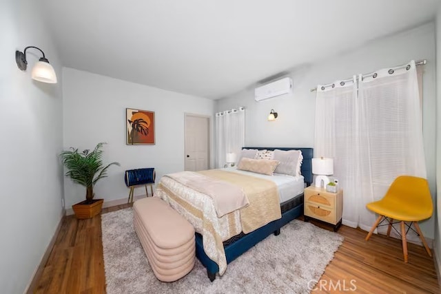 5743 Magnolia Ave, Riverside, CA 92506 - bedroom with a wall mounted air conditioner and wood finished floors