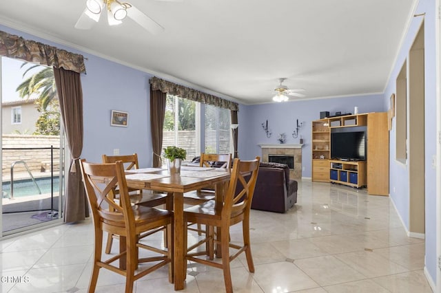 1776 Marsala Way, Camarillo, CA 93012 - dining room featuring ceiling fan, crown molding, a tiled fireplace, and light tile patterned flooring