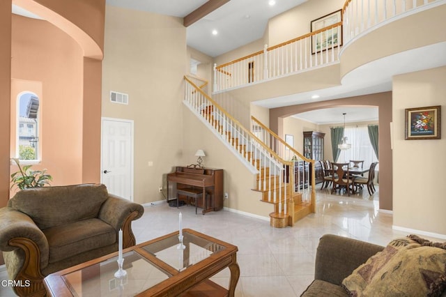 1776 Marsala Way, Camarillo, CA 93012 - living room featuring arched walkways, a towering ceiling, stairs, tile patterned floors, and recessed lighting