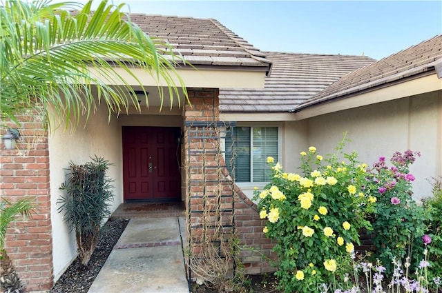 25488 Orange Crest Way, Loma Linda, CA 92354 - doorway to property with stucco siding, brick siding, and a tiled roof