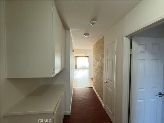 25488 Orange Crest Way, Loma Linda, CA 92354 - hall with brick wall and dark wood-style floors