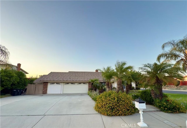 25488 Orange Crest Way, Loma Linda, CA 92354 - view of front of property with driveway, an attached garage, and a chimney