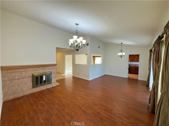25488 Orange Crest Way, Loma Linda, CA 92354 - unfurnished living room featuring a chandelier, lofted ceiling, dark wood-style flooring, and a tile fireplace