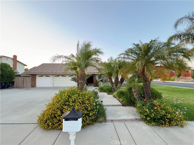 25488 Orange Crest Way, Loma Linda, CA 92354 - view of property hidden behind natural elements featuring driveway and an attached garage