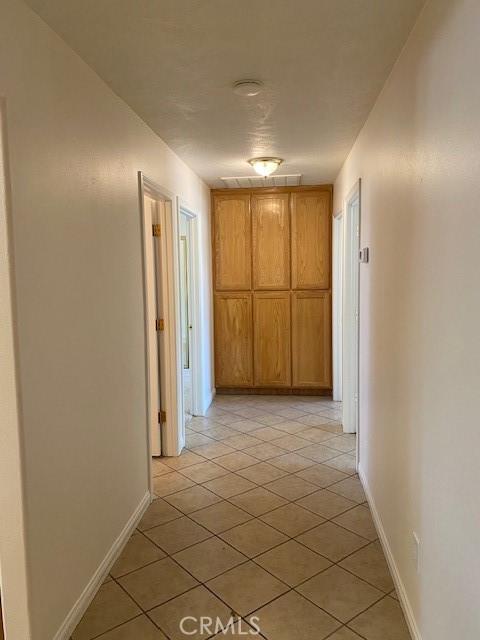 15805 Muscatel St, Hesperia, CA 92345 - corridor featuring light tile patterned floors and baseboards