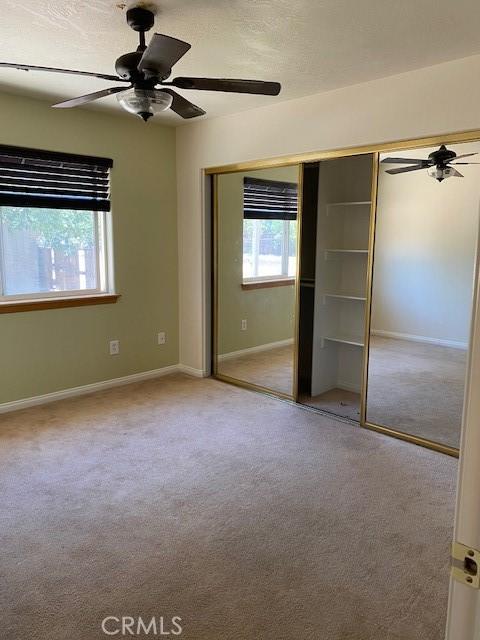 15805 Muscatel St, Hesperia, CA 92345 - unfurnished bedroom featuring carpet flooring, a closet, and a ceiling fan