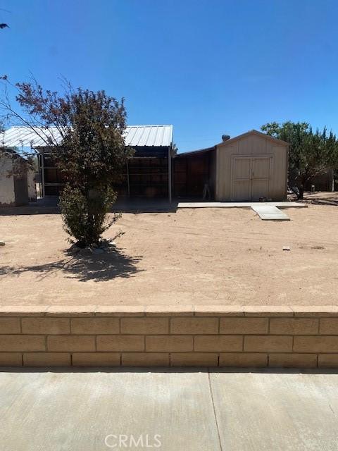 15805 Muscatel St, Hesperia, CA 92345 - view of yard featuring a storage unit