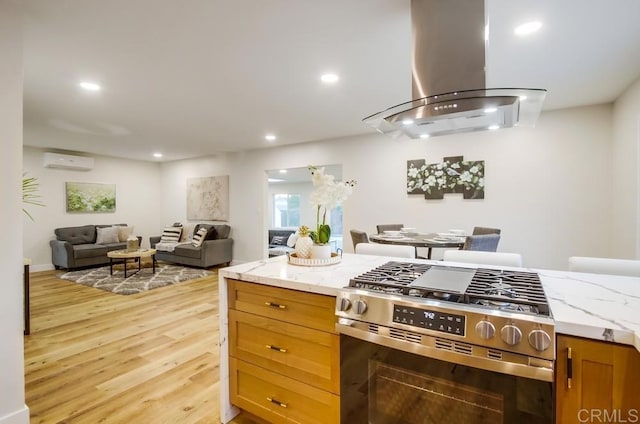 482 Wykes St, Chula Vista, CA 91911 - kitchen with stainless steel gas stove, exhaust hood, open floor plan, light wood-style flooring, and recessed lighting
