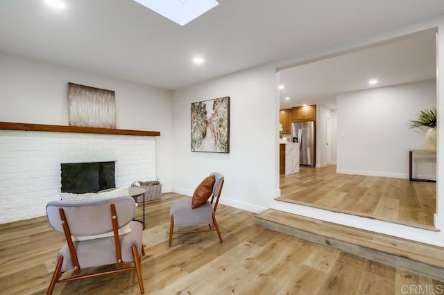 482 Wykes St, Chula Vista, CA 91911 - living area featuring a fireplace, recessed lighting, light wood-type flooring, and a skylight