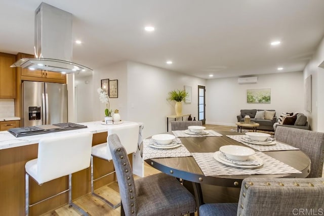 482 Wykes St, Chula Vista, CA 91911 - dining room featuring light wood finished floors, a wall mounted air conditioner, and recessed lighting