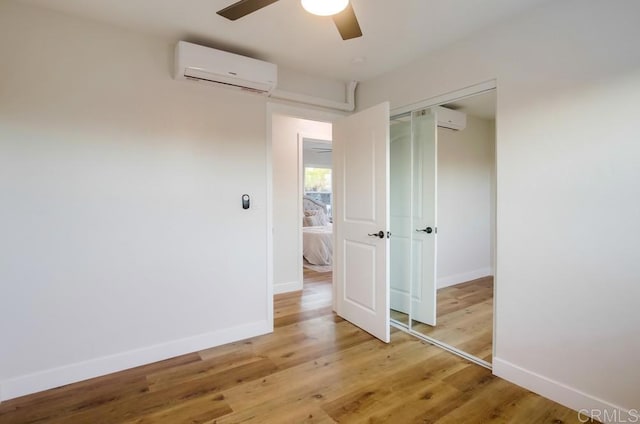 482 Wykes St, Chula Vista, CA 91911 - empty room featuring an AC wall unit, ceiling fan, and light wood finished floors