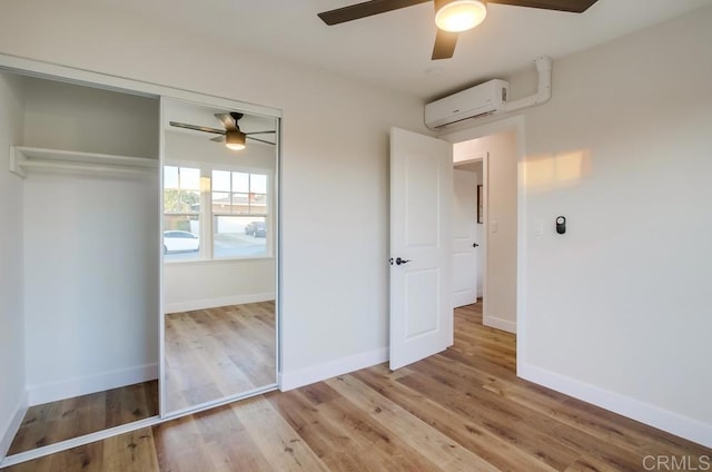 482 Wykes St, Chula Vista, CA 91911 - unfurnished bedroom featuring an AC wall unit, a closet, wood finished floors, and a ceiling fan