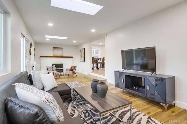 482 Wykes St, Chula Vista, CA 91911 - living area with a skylight, healthy amount of natural light, a brick fireplace, light wood-style floors, and recessed lighting