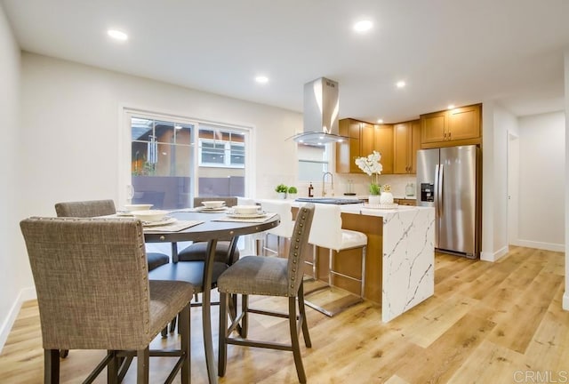 482 Wykes St, Chula Vista, CA 91911 - kitchen featuring stainless steel fridge, island exhaust hood, light wood finished floors, and recessed lighting
