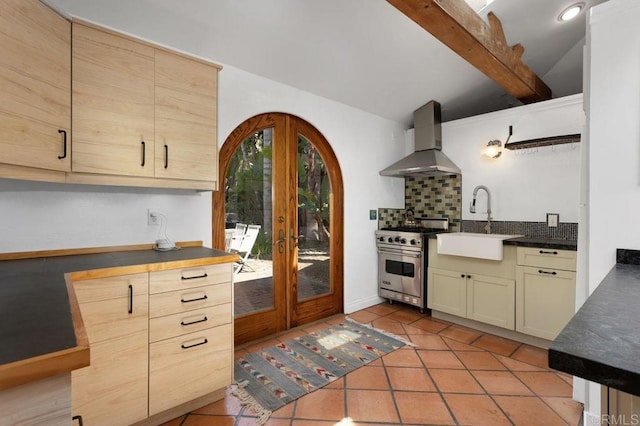 934 Arden Dr, Encinitas, CA 92024 - kitchen featuring wall chimney exhaust hood, high end range, french doors, dark countertops, and decorative backsplash