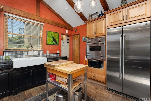 934 Arden Dr, Encinitas, CA 92024 - kitchen featuring appliances with stainless steel finishes, beamed ceiling, dark wood-style floors, decorative backsplash, and light countertops