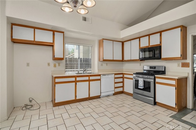7353 Cascade Ct, Rancho Cucamonga, CA 91730 - kitchen featuring dishwasher, black microwave, gas stove, light countertops, and vaulted ceiling