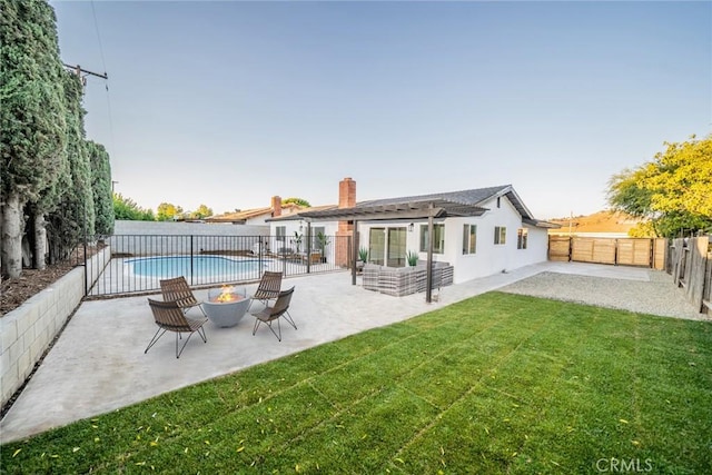 5955 Scheelite St, Jurupa Valley, CA 92509 - back of property featuring a patio, a fenced backyard, an outdoor fire pit, a chimney, and stucco siding