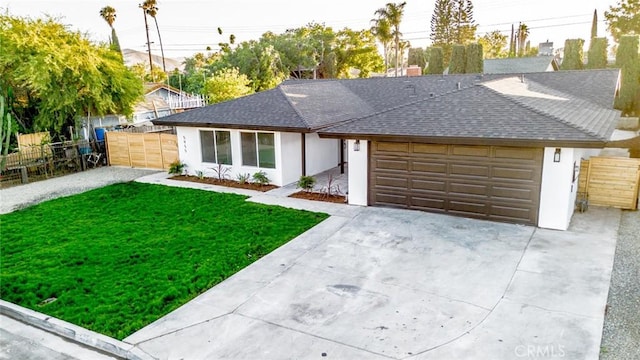 5955 Scheelite St, Jurupa Valley, CA 92509 - ranch-style home with a shingled roof, a garage, concrete driveway, and stucco siding