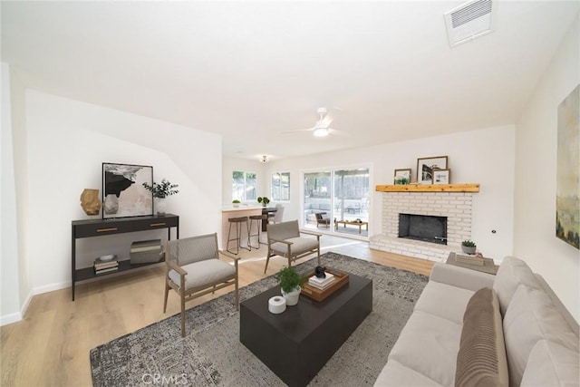 5955 Scheelite St, Jurupa Valley, CA 92509 - living area with wood finished floors, a ceiling fan, and a brick fireplace
