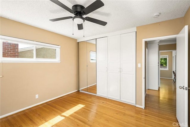 15027 Barnwall St, La Mirada, CA 90638 - unfurnished bedroom featuring light wood finished floors, a closet, a textured ceiling, and a ceiling fan