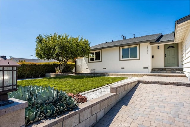 15027 Barnwall St, La Mirada, CA 90638 - view of front of home with crawl space, a front lawn, a shingled roof, stucco siding, and a patio area