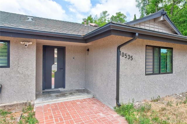 10535 Reseda Blvd, Porter Ranch, CA 91326 - doorway to property with stucco siding and a shingled roof