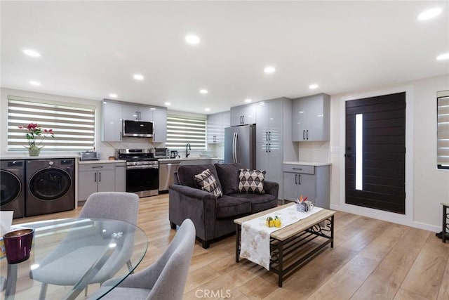 10535 Reseda Blvd, Porter Ranch, CA 91326 - living room with independent washer and dryer, light wood-style flooring, and recessed lighting