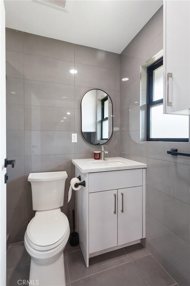 10535 Reseda Blvd, Porter Ranch, CA 91326 - bathroom with tile walls, vanity, and tile patterned flooring