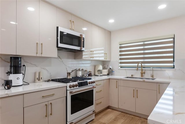 10535 Reseda Blvd, Porter Ranch, CA 91326 - kitchen featuring high end range, stainless steel microwave, tasteful backsplash, light wood-style flooring, and recessed lighting