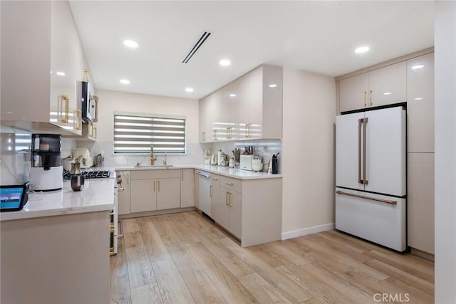 10535 Reseda Blvd, Porter Ranch, CA 91326 - kitchen with white appliances, light wood-type flooring, recessed lighting, and decorative backsplash