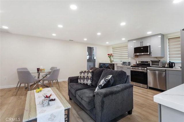 10535 Reseda Blvd, Porter Ranch, CA 91326 - living room featuring recessed lighting, light wood-style floors, and washer and clothes dryer