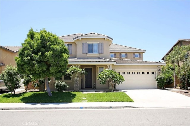 5621 Avocet Dr, Jurupa Valley, CA 91752 - view of front of house with driveway, stucco siding, and an attached garage