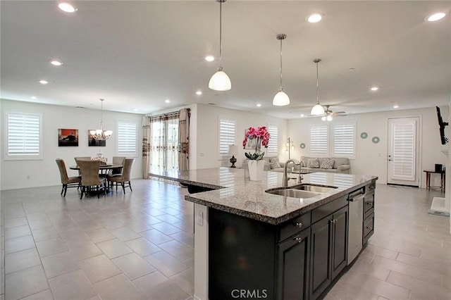 5621 Avocet Dr, Jurupa Valley, CA 91752 - kitchen with open floor plan, recessed lighting, a kitchen island with sink, light stone counters, and a chandelier
