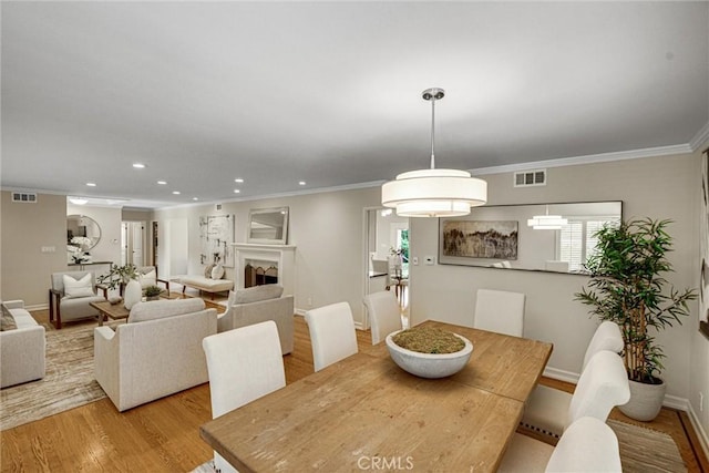 4843 Texhoma Ave, Encino, CA 91316 - dining area featuring light wood-style flooring, ornamental molding, and recessed lighting