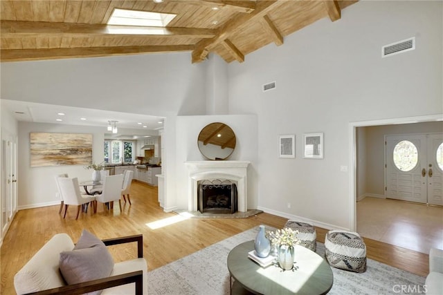 4843 Texhoma Ave, Encino, CA 91316 - living room featuring a wooden ceiling with exposed beams, high vaulted ceiling, light wood-style flooring, a fireplace, and recessed lighting