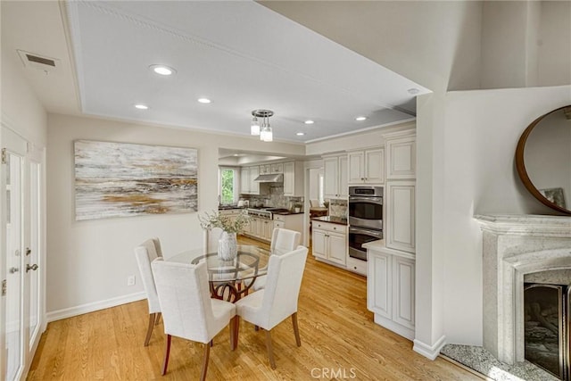 4843 Texhoma Ave, Encino, CA 91316 - dining space featuring a fireplace, light wood finished floors, and recessed lighting