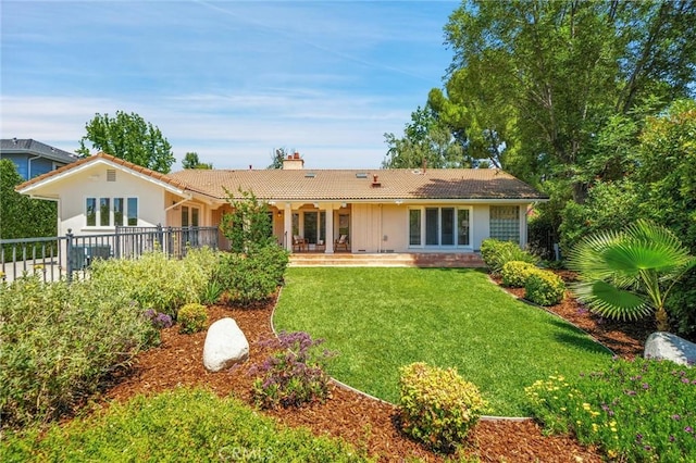 4843 Texhoma Ave, Encino, CA 91316 - rear view of house with a yard, a chimney, stucco siding, and a tile roof