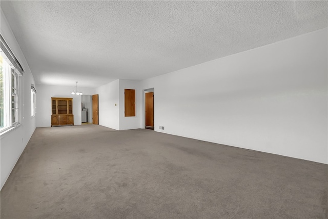 824 De La Fuente St, Monterey Park, CA 91754 - unfurnished living room with a chandelier, carpet, and a textured ceiling