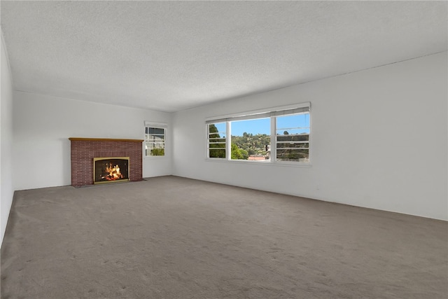 824 De La Fuente St, Monterey Park, CA 91754 - unfurnished living room with carpet flooring, a textured ceiling, and a brick fireplace