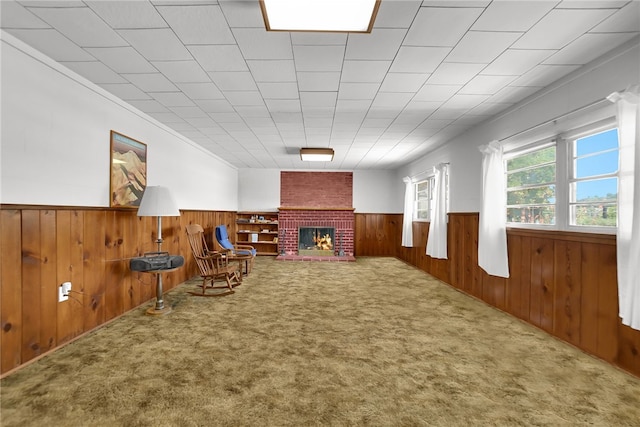 824 De La Fuente St, Monterey Park, CA 91754 - living area featuring wainscoting, wood walls, carpet flooring, and a brick fireplace